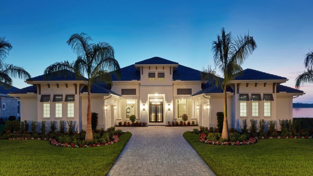 Luxury house with palm trees and lit entrance