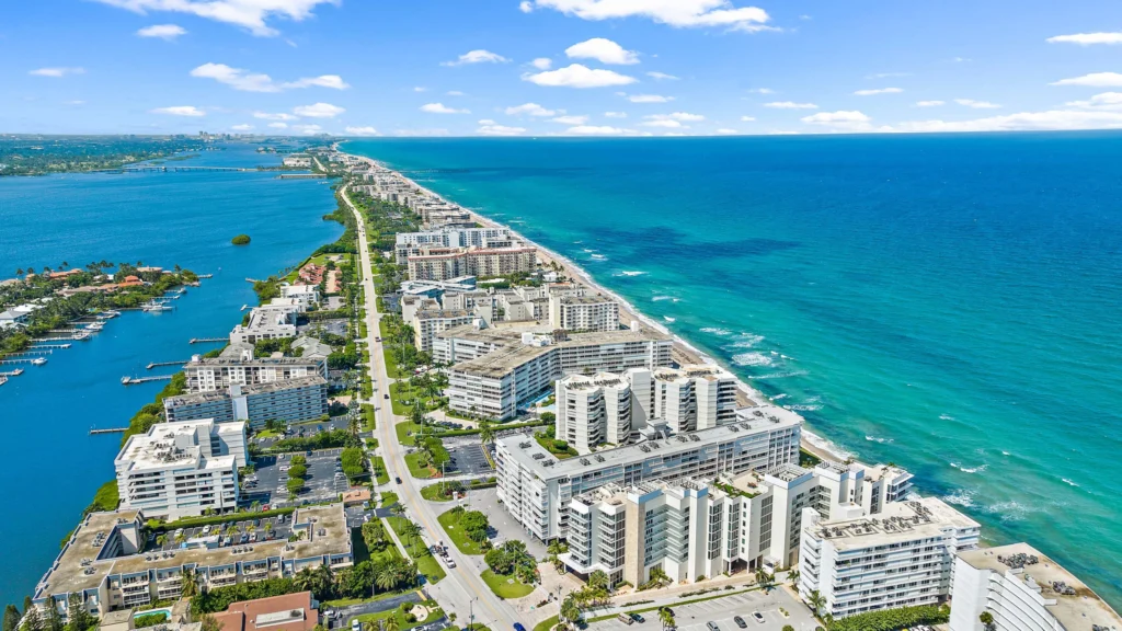 Aerial view of beachfront condos along turquoise ocean