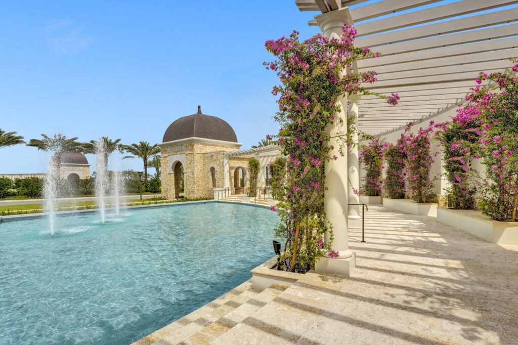 Resort pool with fountains and flowering pergola