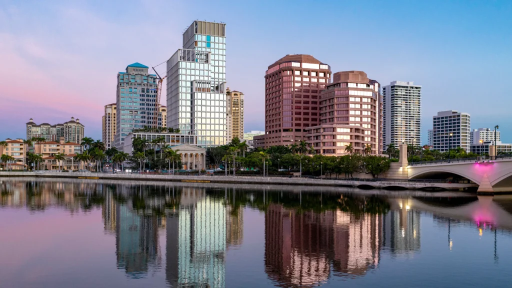 Dusk city skyline reflected on calm waterfront
